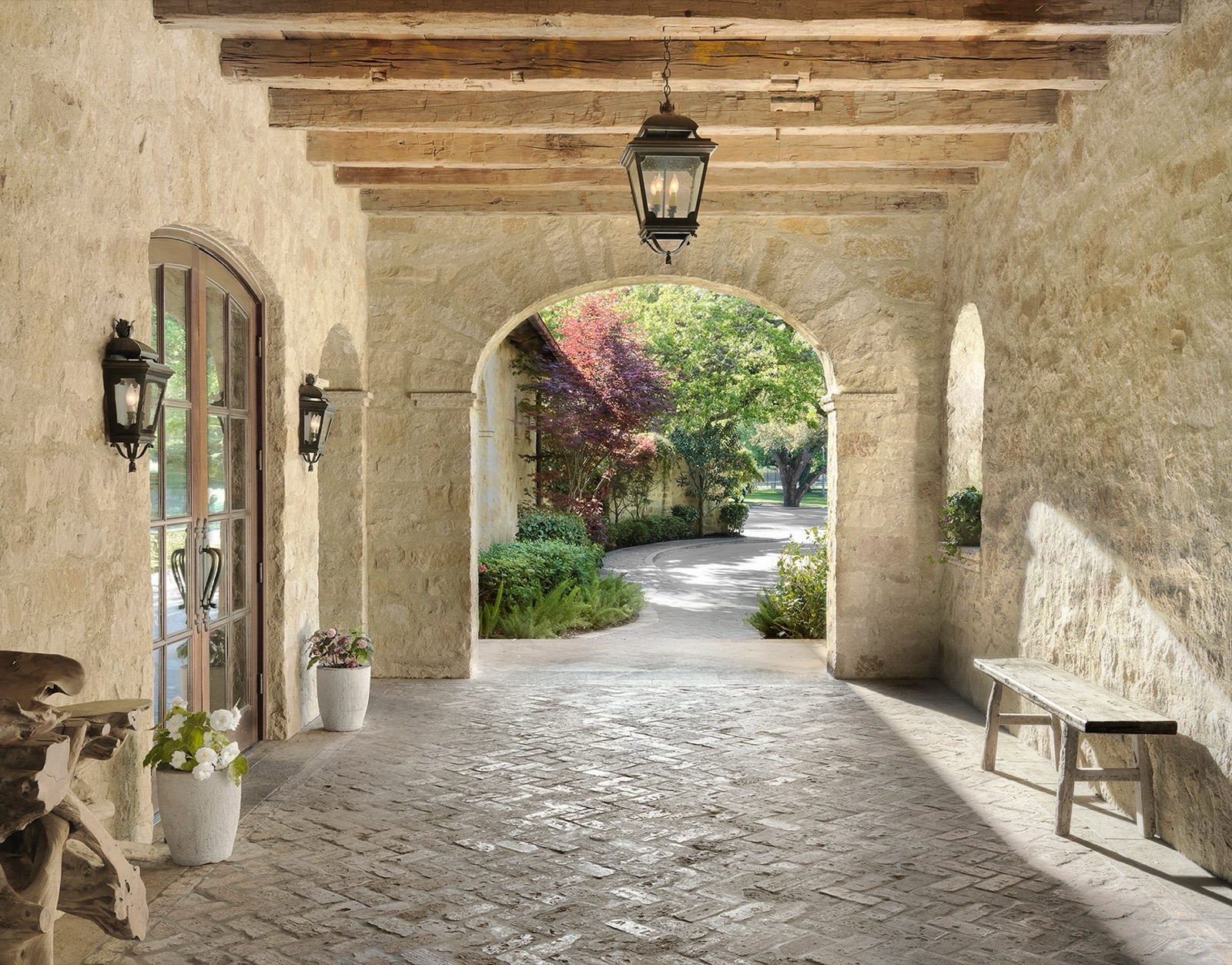 Stone archway loggia with reclaimed wood beam accents
